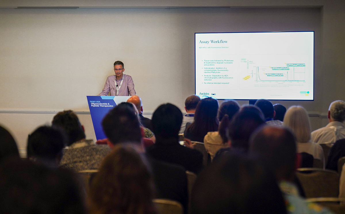 Axolabs presenting to an audience at TIDES US 2025