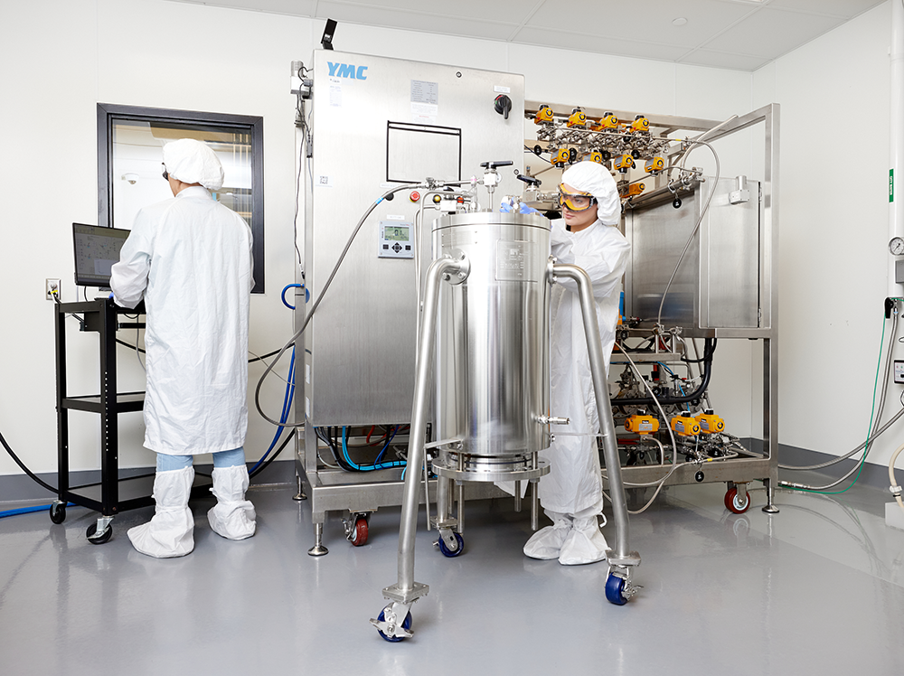 Image shows Axolabs scientists working at YMC purifier